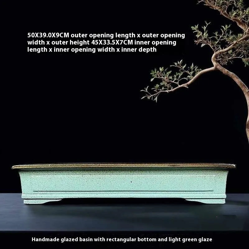 Green handmade ceramic bonsai flower pot with purple sand crackle glaze finish.