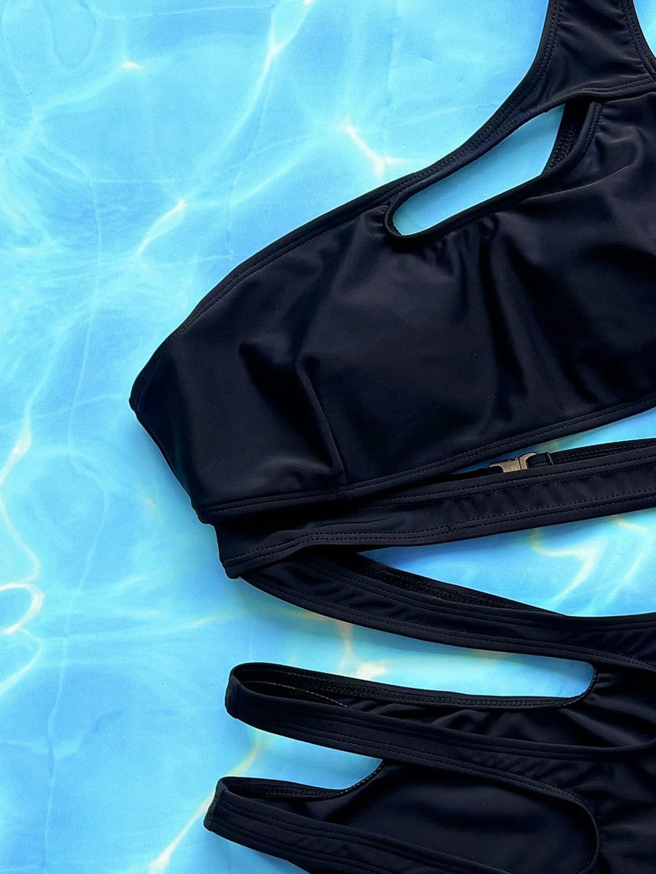 Black women's one-piece swimsuit with hollow out straps showing front and back views