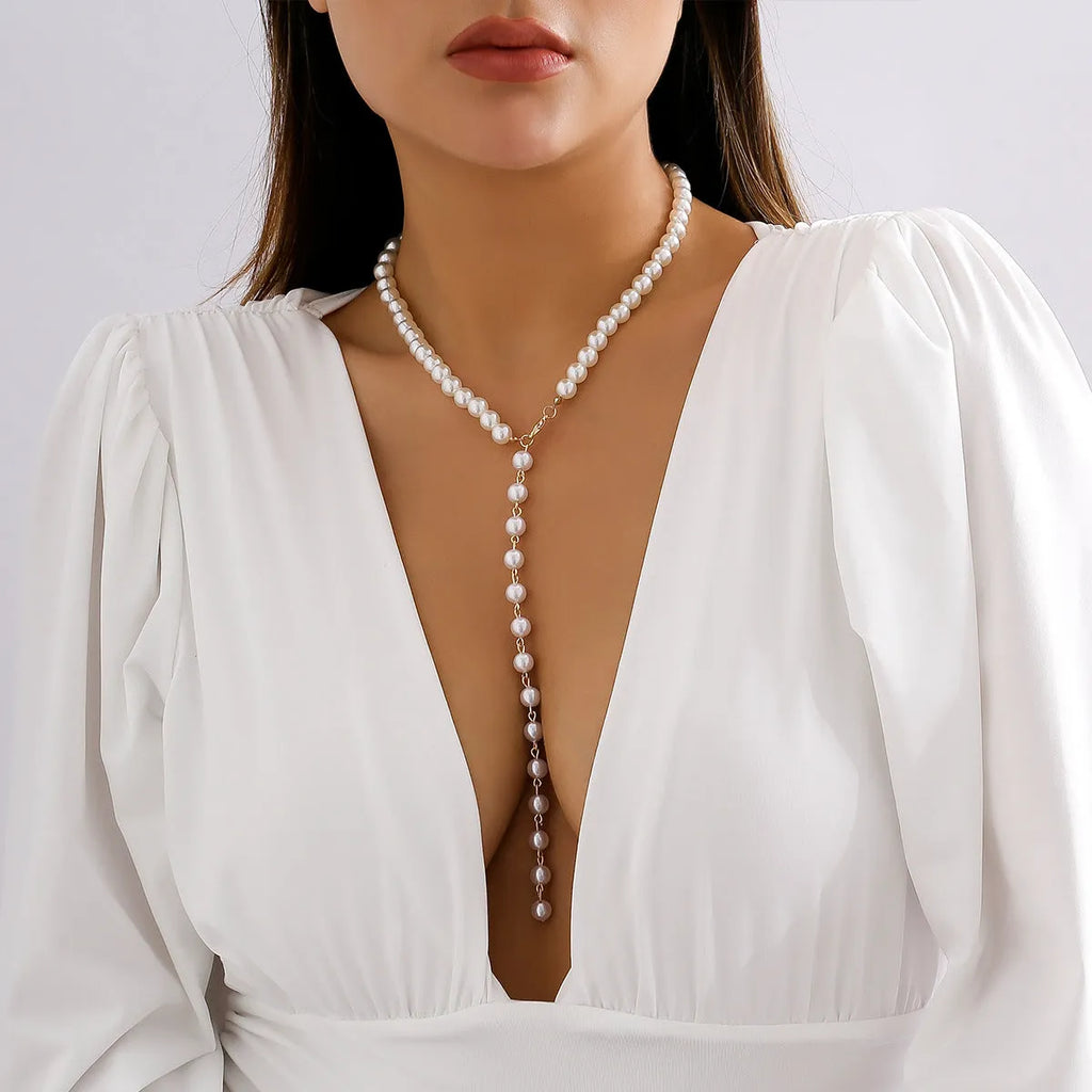 Round beads imitation pearl necklace on display showing gold colour metal chain