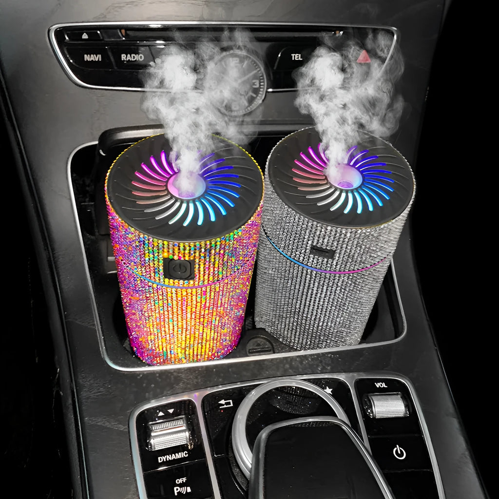 Compact white diamond car air humidifier on a car dashboard with USB cable.