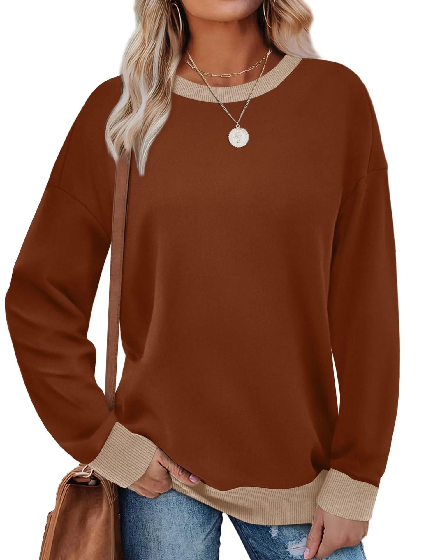 Women's loose round neck striped long sleeve top in apricot colour on a hanger.