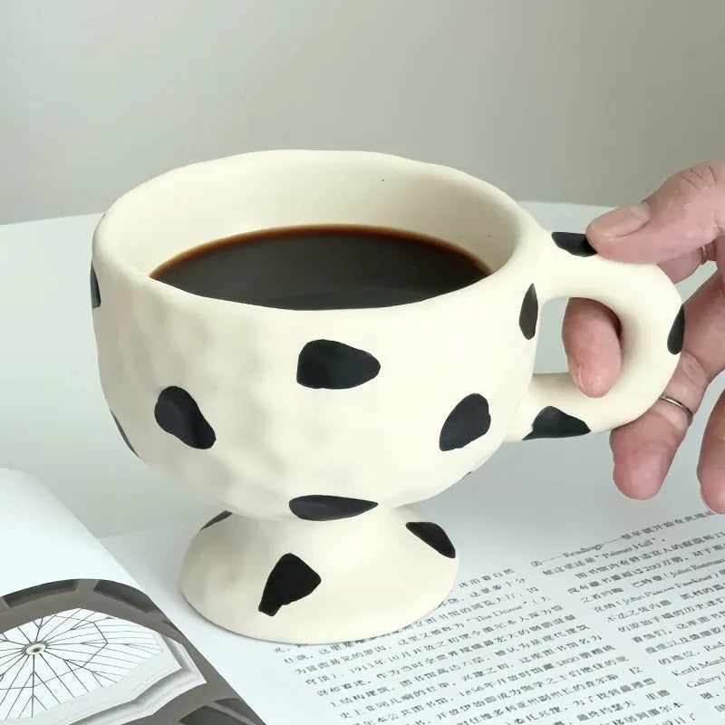 Hand-pinched irregular ceramic mug in a solid colour on a plain background.