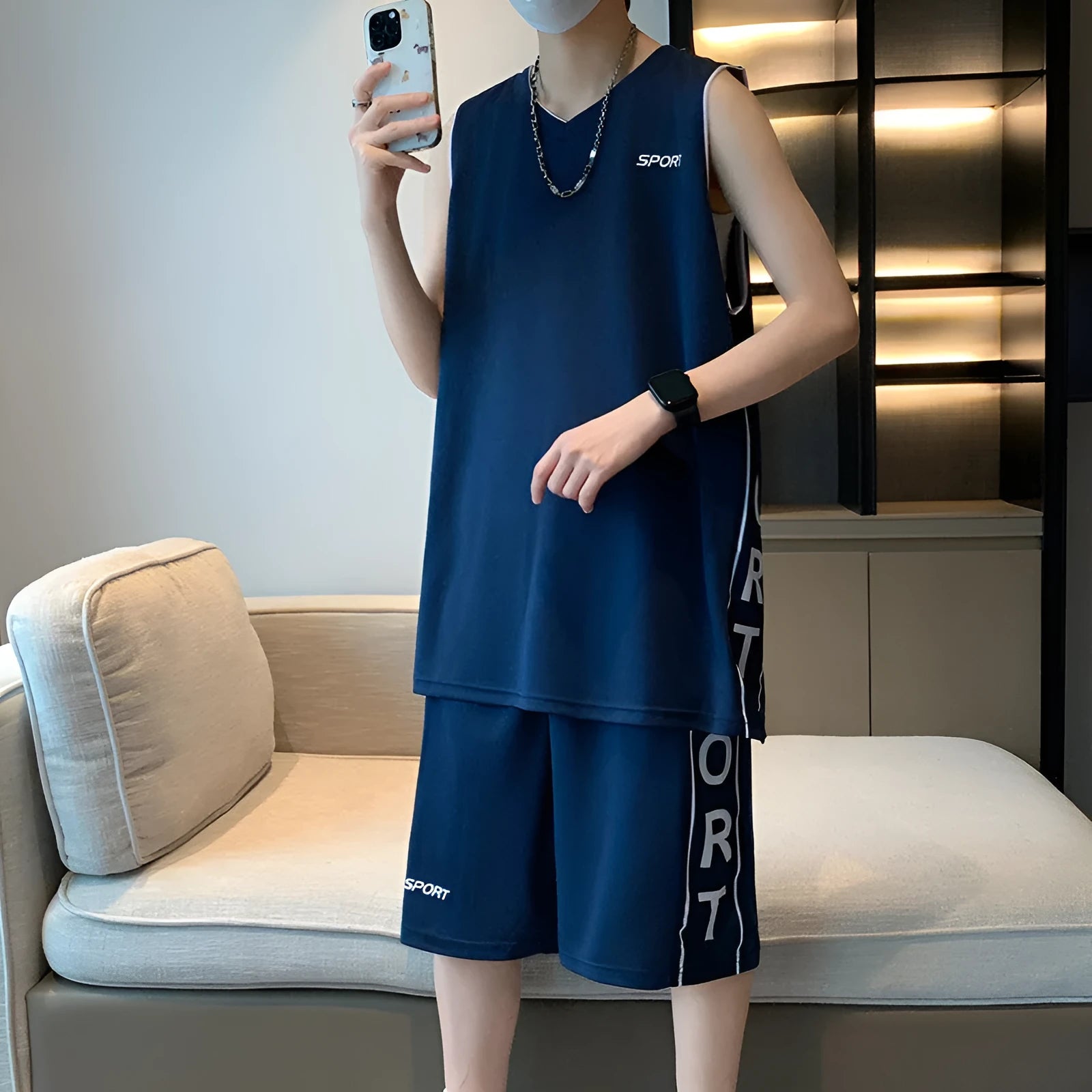 Men's white sleeveless basketball vest and matching shorts sportswear set laid flat.