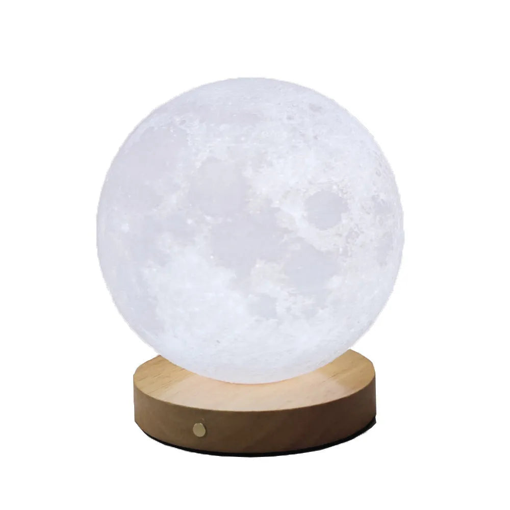 Rotating sleeping moon night lamp on a wooden base with a wire control, showing three colour options.