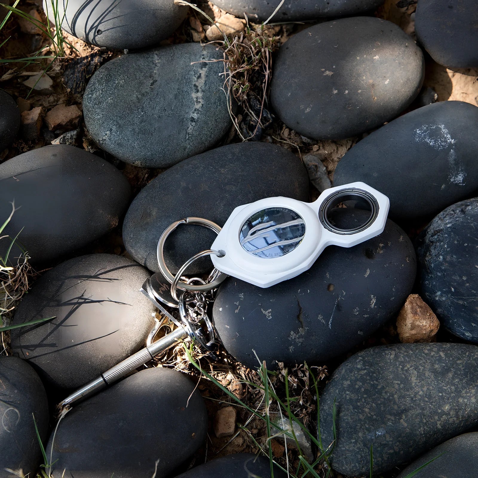 White zinc alloy Apple AirTag keychain case with protective cover and swivel keyring