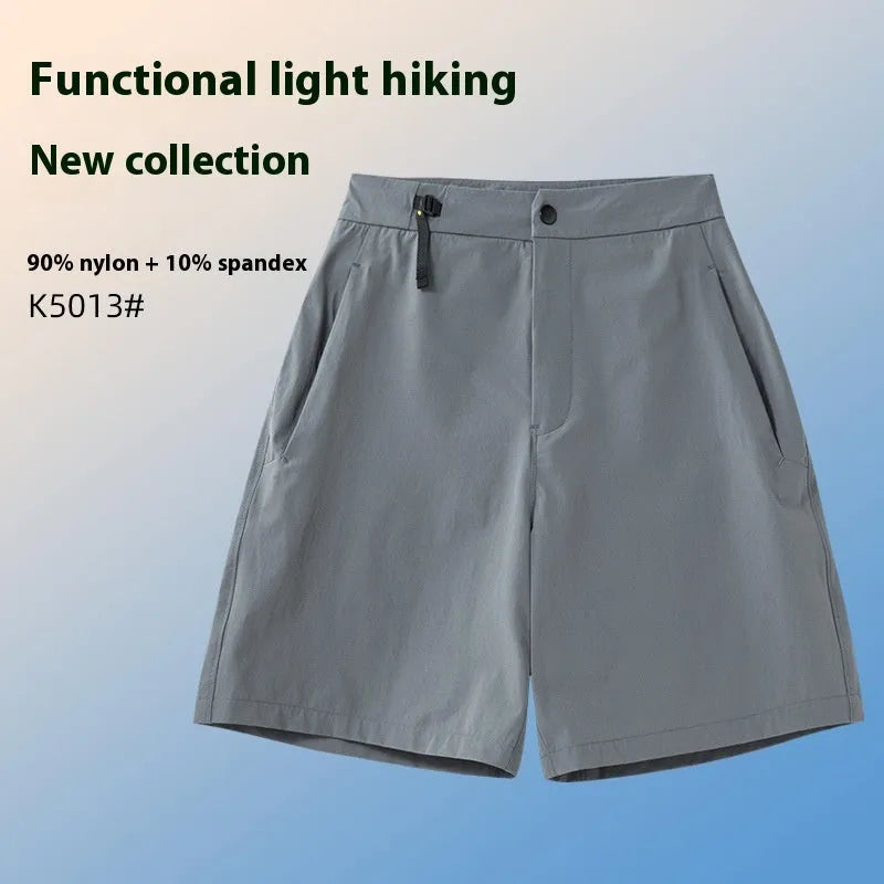 Man wearing khaki quick-dry sports shorts with four-way stretch on a running track.