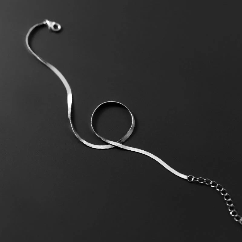 S925 silver snake bone chain anklet in silver and gold finishes, showcasing unique design and craftsmanship.