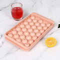 Large blue silicone ice cube tray with lid showing 33 round cavities.