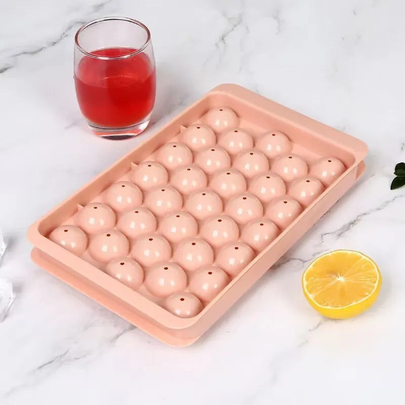 Large blue silicone ice cube tray with lid showing 33 round cavities.