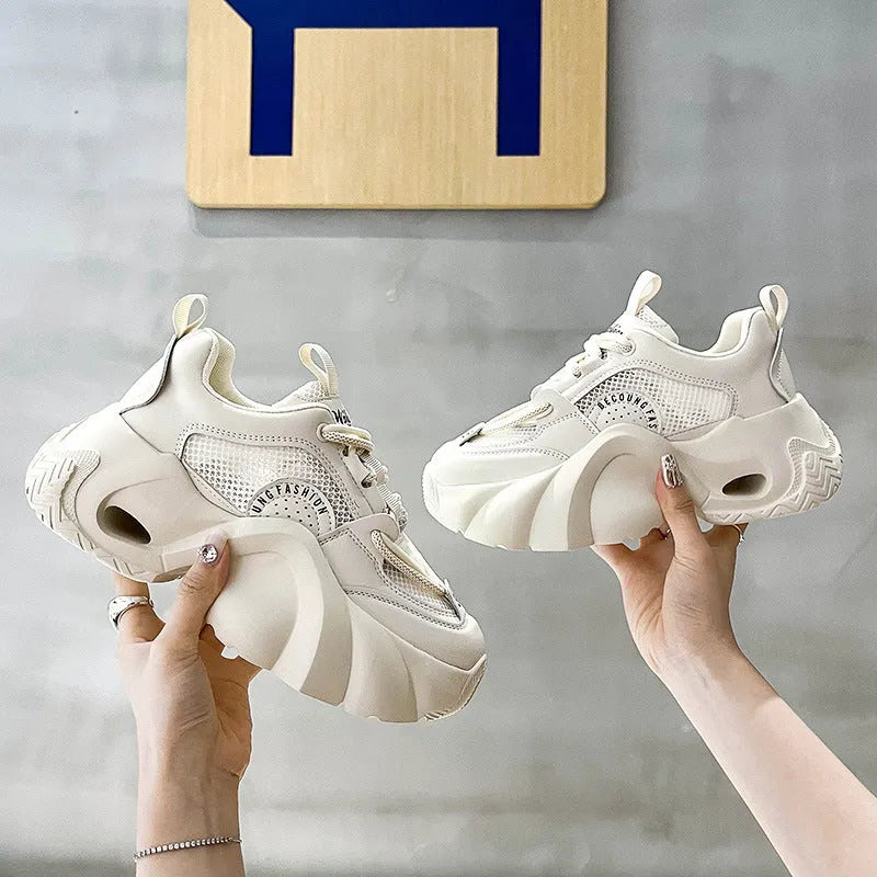 Women's beige casual sneakers with cross shoulder straps and a thick sole.