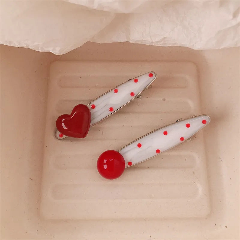 Red stereo love heart-shaped hair clip with French retro dots and willow leaf design.