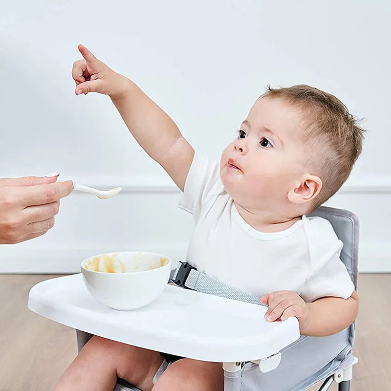 Foldable baby dining chair in folding grey with removable tray and safety belt, includes storage bag