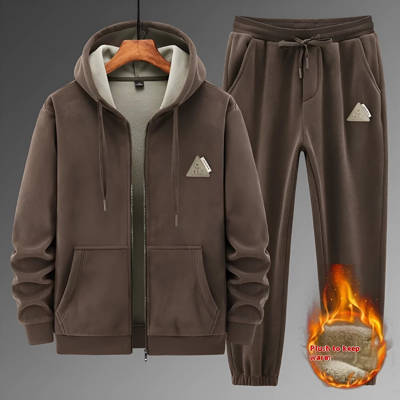 Man wearing a grey hooded cashmere sweater and matching cotton trousers from a casual sports suit set.