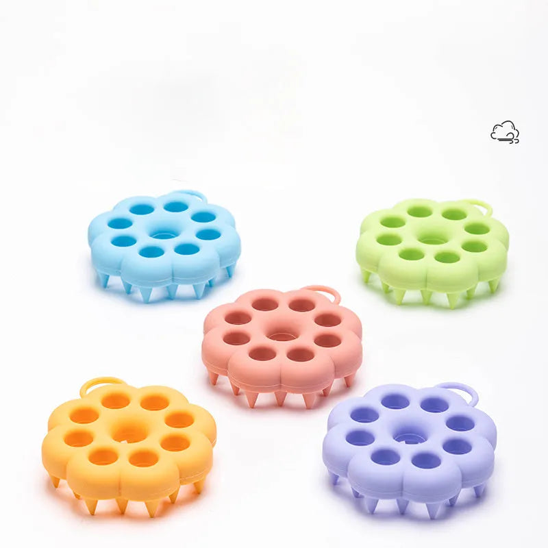 Silicone pet grooming brush with ergonomic handle shown in multiple colours: blue, green, orange, pink, purple.