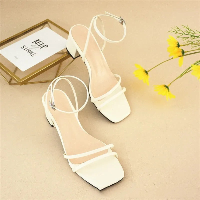 Beige women's stiletto sandals with a chunky block heel and an adjustable ankle buckle strap.