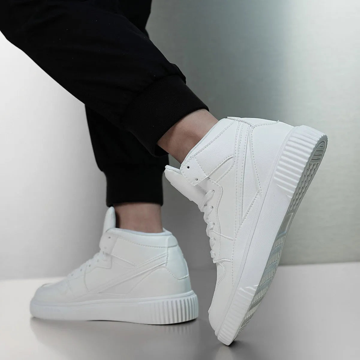White men's casual slip-on shoes with a round toe and microfiber upper on a solid background.