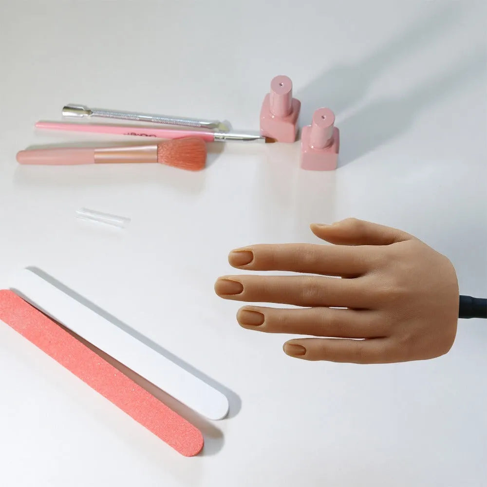 Silicone nail art practice hand model showing articulated fingers on a tabletop.