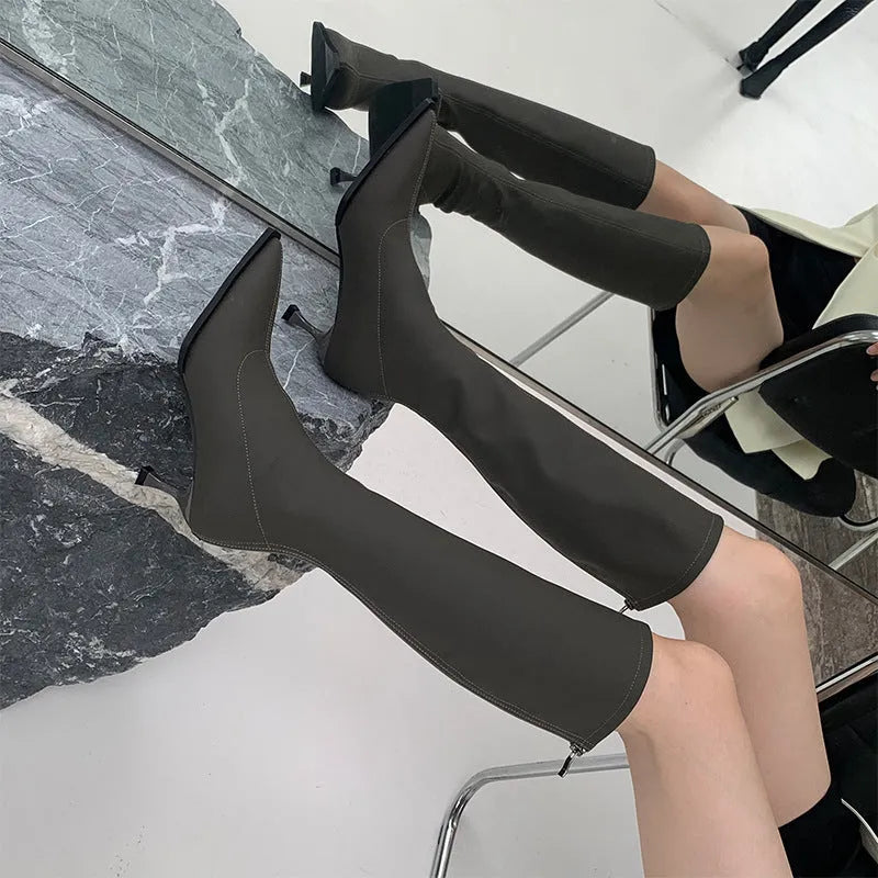 Black women's ankle boots with a pointed toe, stiletto heel, and a back zip fastening.