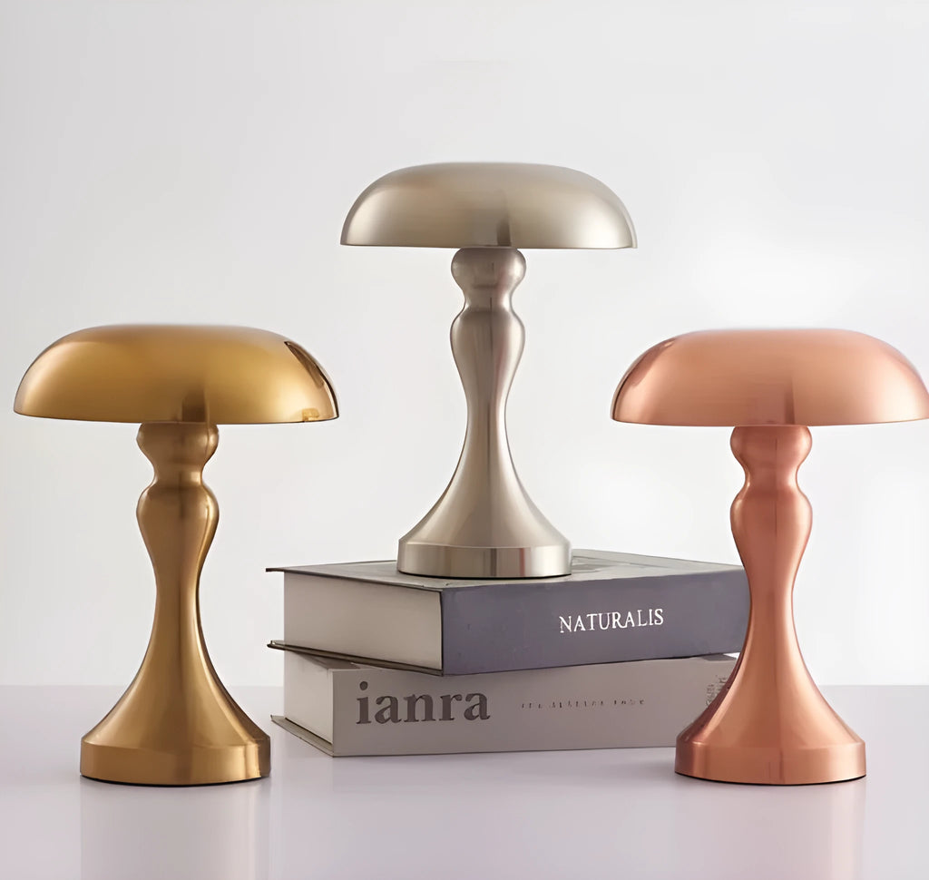 Metallic bronze LED desk lamp with touch control on a wooden desk next to a book.