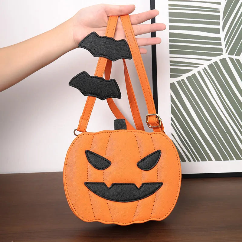 Horizontal view of a PU crossbody bag with pumpkin and bat cartoon design in orange colour option.