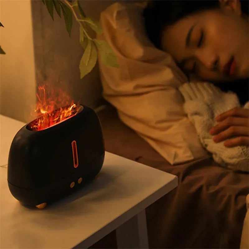 Dark grey flame humidifier with realistic orange LED light and mist output on a wooden table