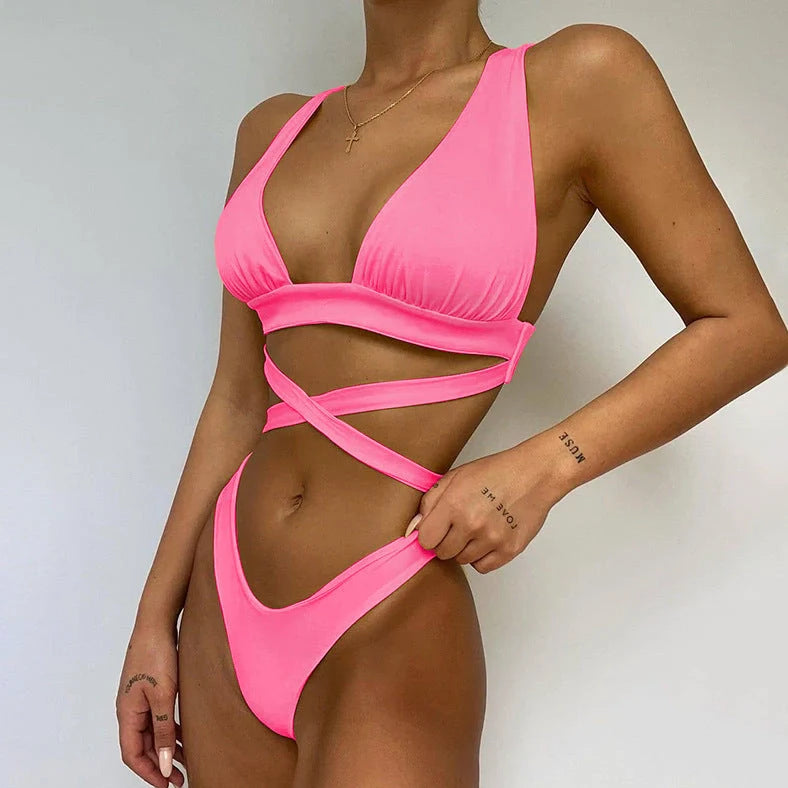 Women's solid colour cross bikini swimsuit with removable chest pads in black, showing front design detail