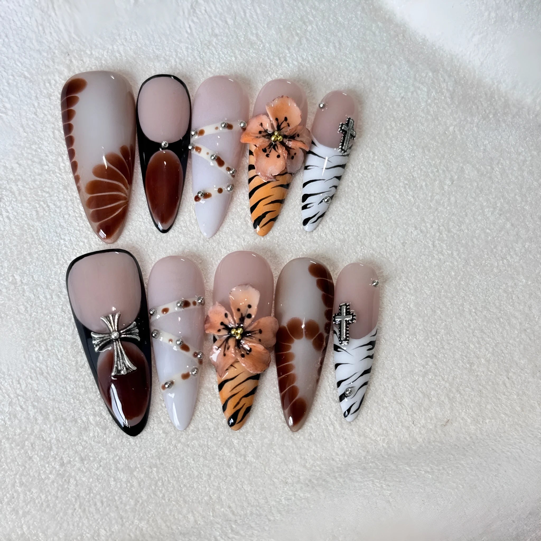 Pack of 10 leopard print, floral, and cross pattern nail stickers in sizes XS, S, M, L.