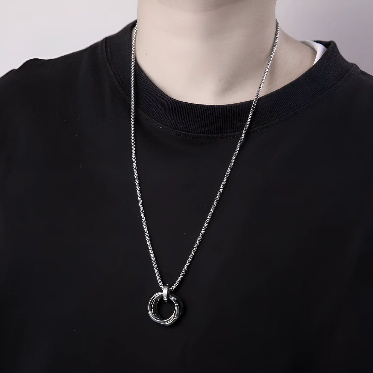 Men's geometric pendant necklace in titanium steel with electroplated black finish on a simple chain