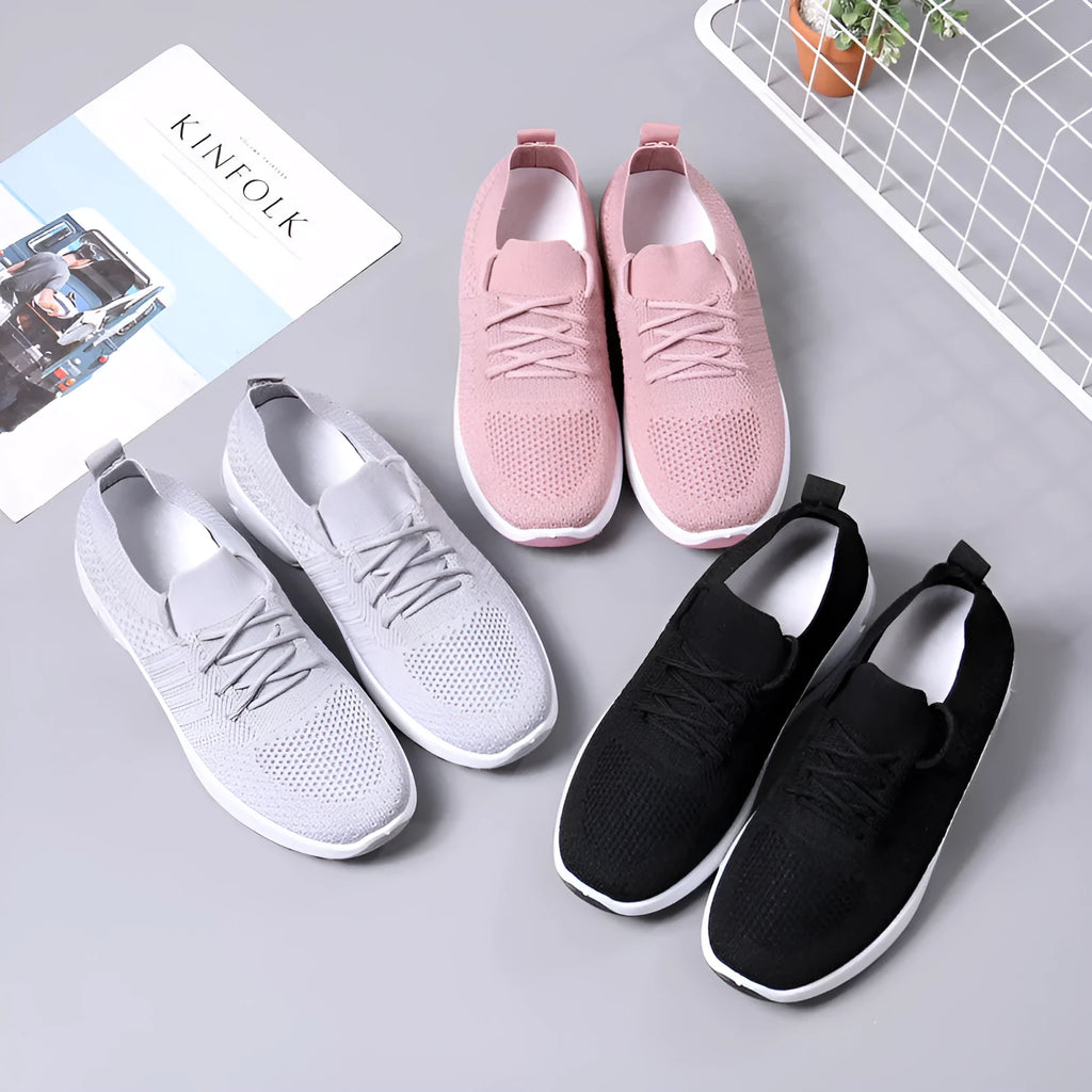 Women's casual mesh sneakers in black with round toe and lace-up front, showing PVC sole