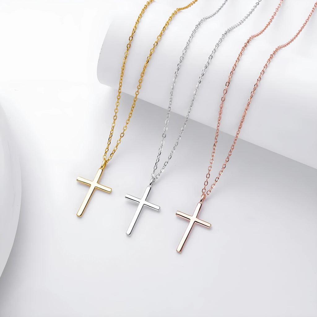 Simple glossy cross pendant on an O-shaped sterling silver chain necklace.