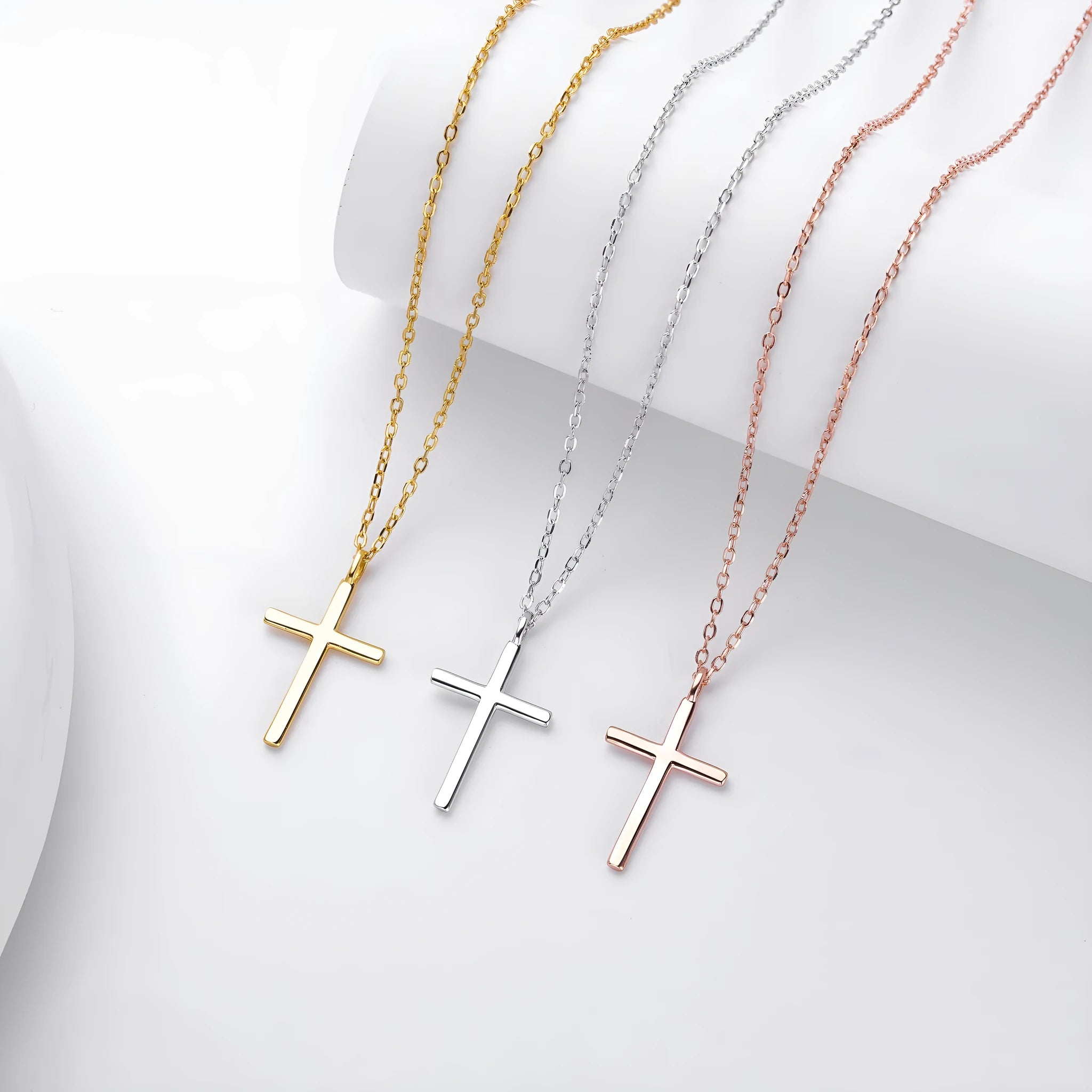 Simple glossy cross pendant on an O-shaped sterling silver chain necklace.