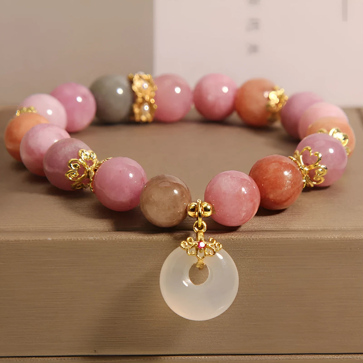Macaron tourmaline peace buckle pendant bracelet on neutral background, women's retro style
