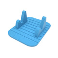 Silicone octopus ball mobile phone holder in blue holding a smartphone on a desk