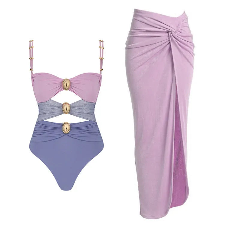 Women's solid colour one-piece swimsuit with detachable skirt featuring gold button detail
