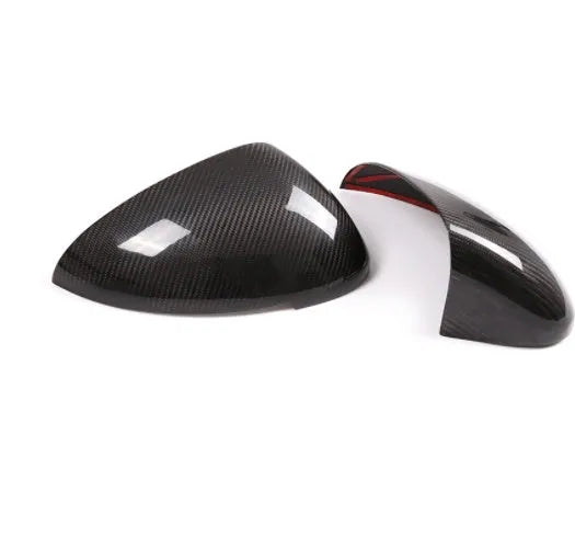 True carbon fibre exterior mirror covers for a Porsche Macan, shown in high-gloss black.