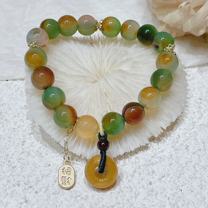 Yellow women's folk bracelet with peacock agate and topaz stones and a peace buckle clasp.