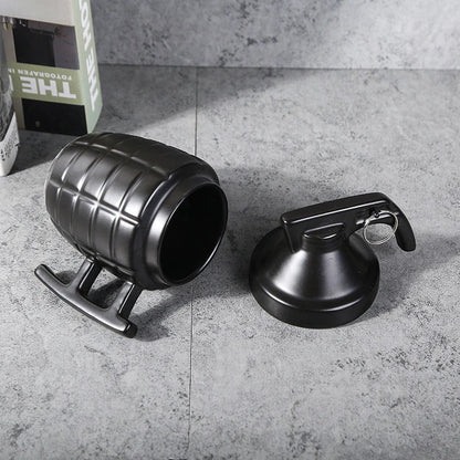 A grenade-shaped ceramic coffee mug with a lid, featuring a military-inspired design for a unique and tactical look.