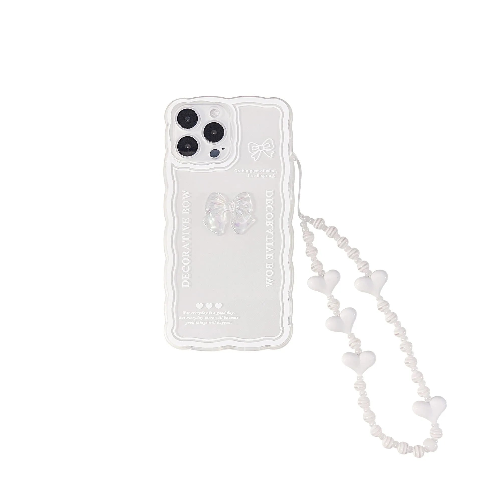 Clear iPhone case with a raised 3D bow design on the back, shown next to a white love lanyard.