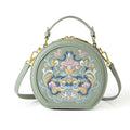 Small crossbody round bag in khaki with national-style embroidery and sewing line details, shown on a plain background