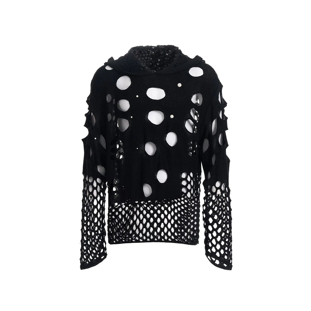 Man wearing a black loose-fit hollow knit hoodie with pearl decorations on the hood.