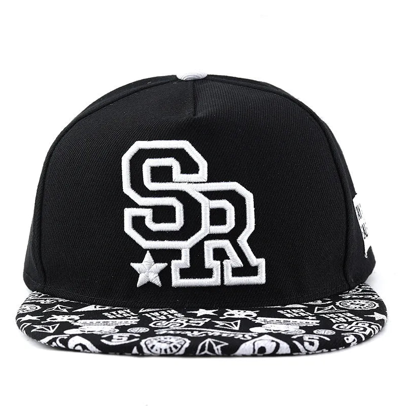 Black and white cotton baseball cap with letter embroidery on the front, showing adjustable strap at back.