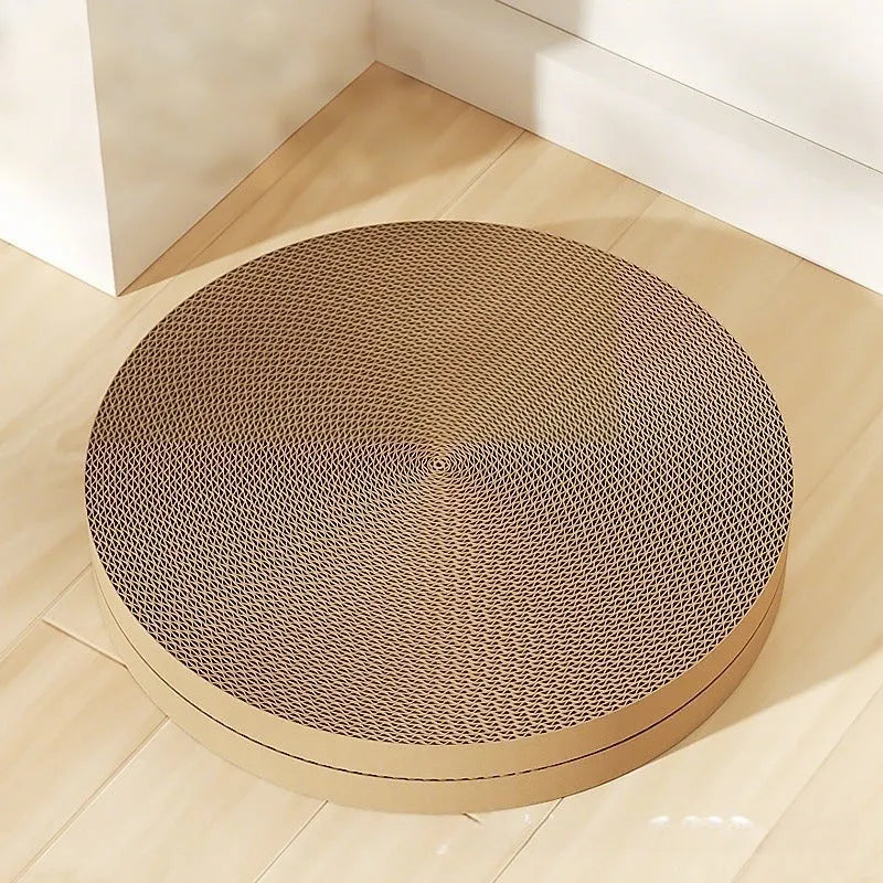 A round green cat scratching board made of corrugated cardboard, 55cm across, with two spare refills.