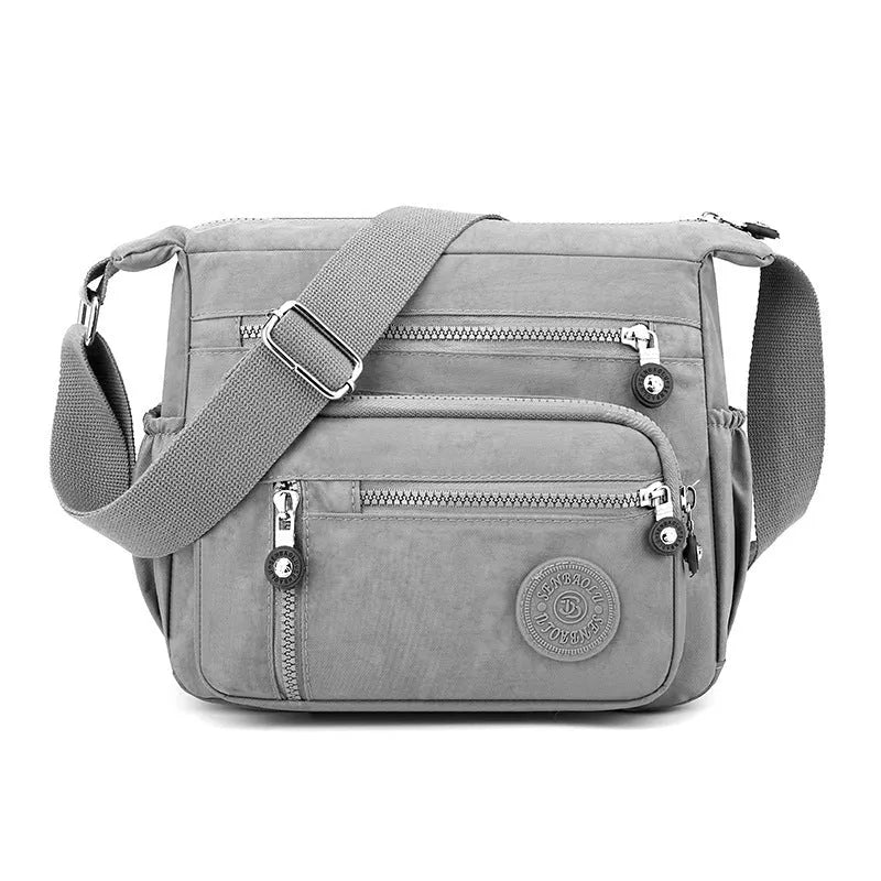 Lightweight grey nylon shoulder messenger bag with a single strap, shown in a square vertical shape.