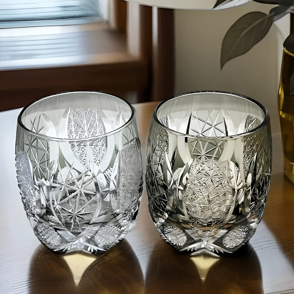 Four Japanese-style Edo crystal glass whisky tumblers in amber and clear cut-glass designs placed in wooden box