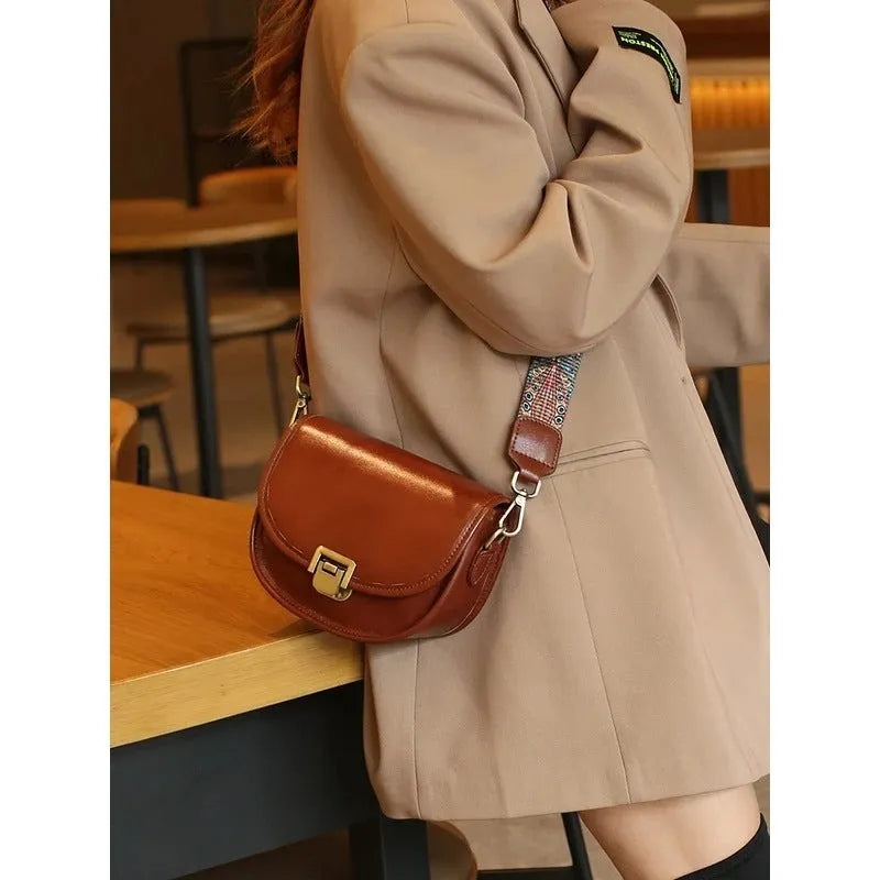 Vegetable tanned top layer cowhide half moon shoulder bag with lock detail, black colour, sandwich pocket, double straps