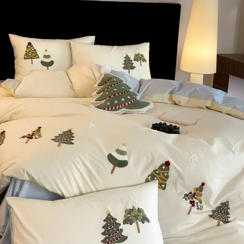 Cream blue cotton duvet cover and pillowcases with embroidered green Christmas tree and flower design.