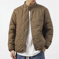 Men's black diamond lattice pattern winter jacket with lengthened cut on mannequin
