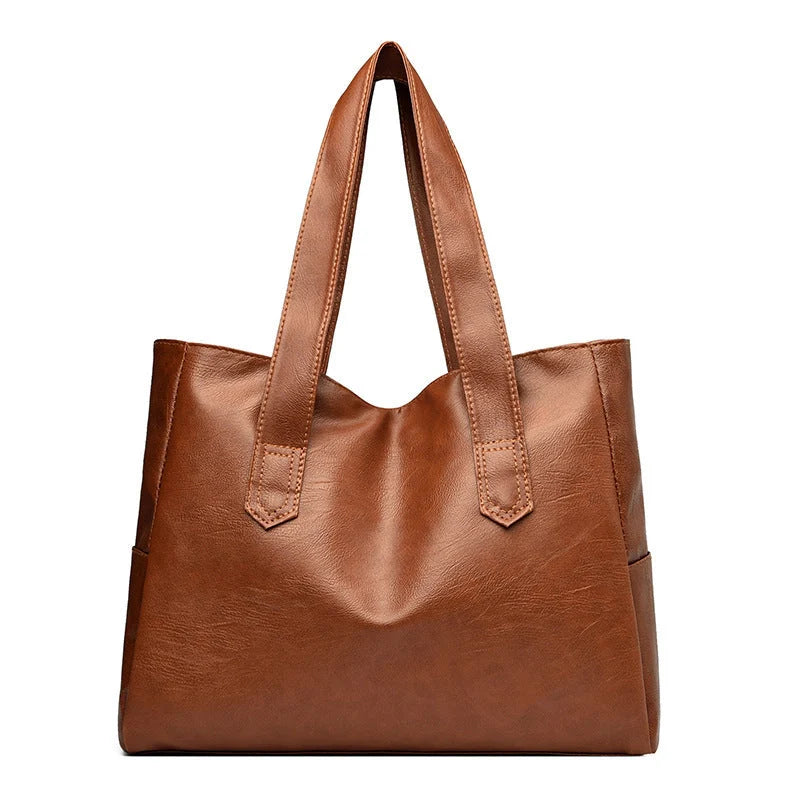 Large capacity commuter tote bag in brown and black with double shoulder straps and mobile phone pocket