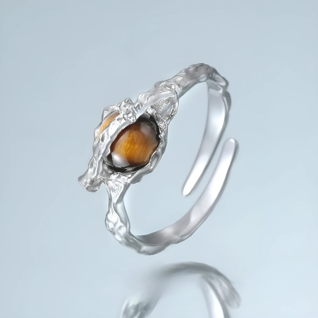 White gold colour Saturn open ring with adjustable opening on silver background