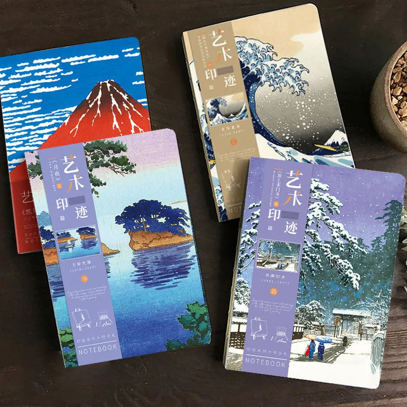 Ukiyo-e art hand ledger notebook open on a desk showing detailed Kanagawa wave cover and lined pages.